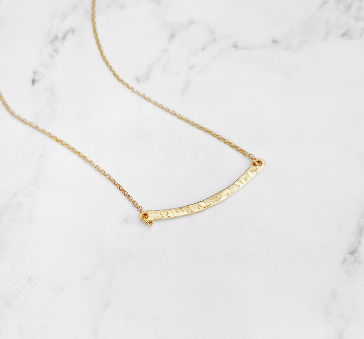 Solid yellow gold necklace with a thin hammered bar from Whisper Gold's Simple Necklaces collection
