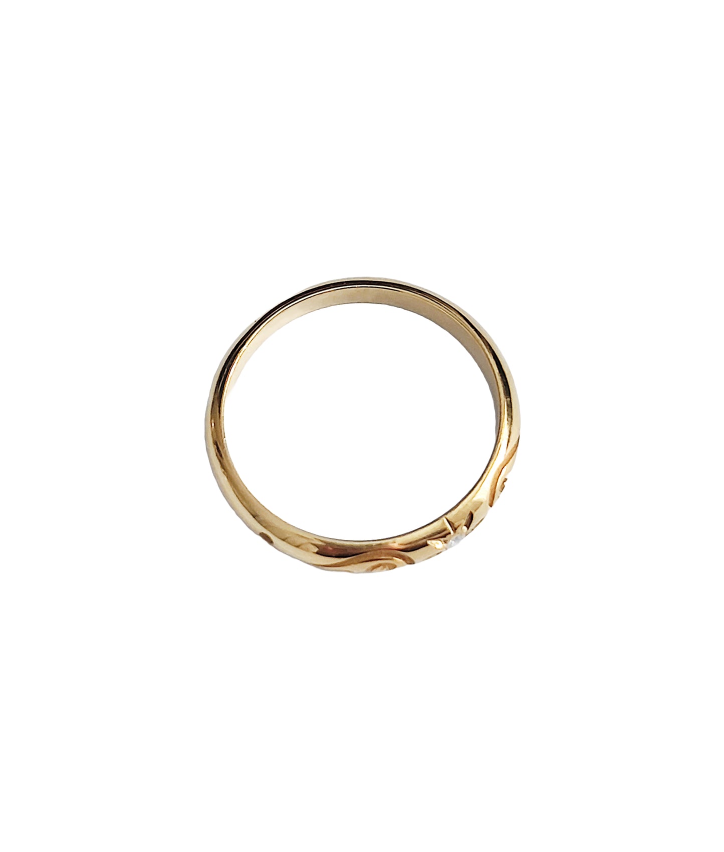 top view of solid yellow gold dome band ring with floral designs and set with a white diamond with a star polaris setting