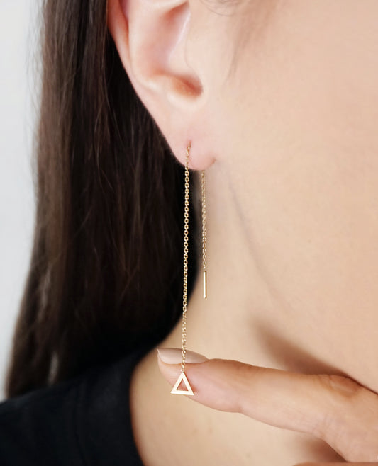 female wearing solid yellow gold threader pull through earring with tiny triangle