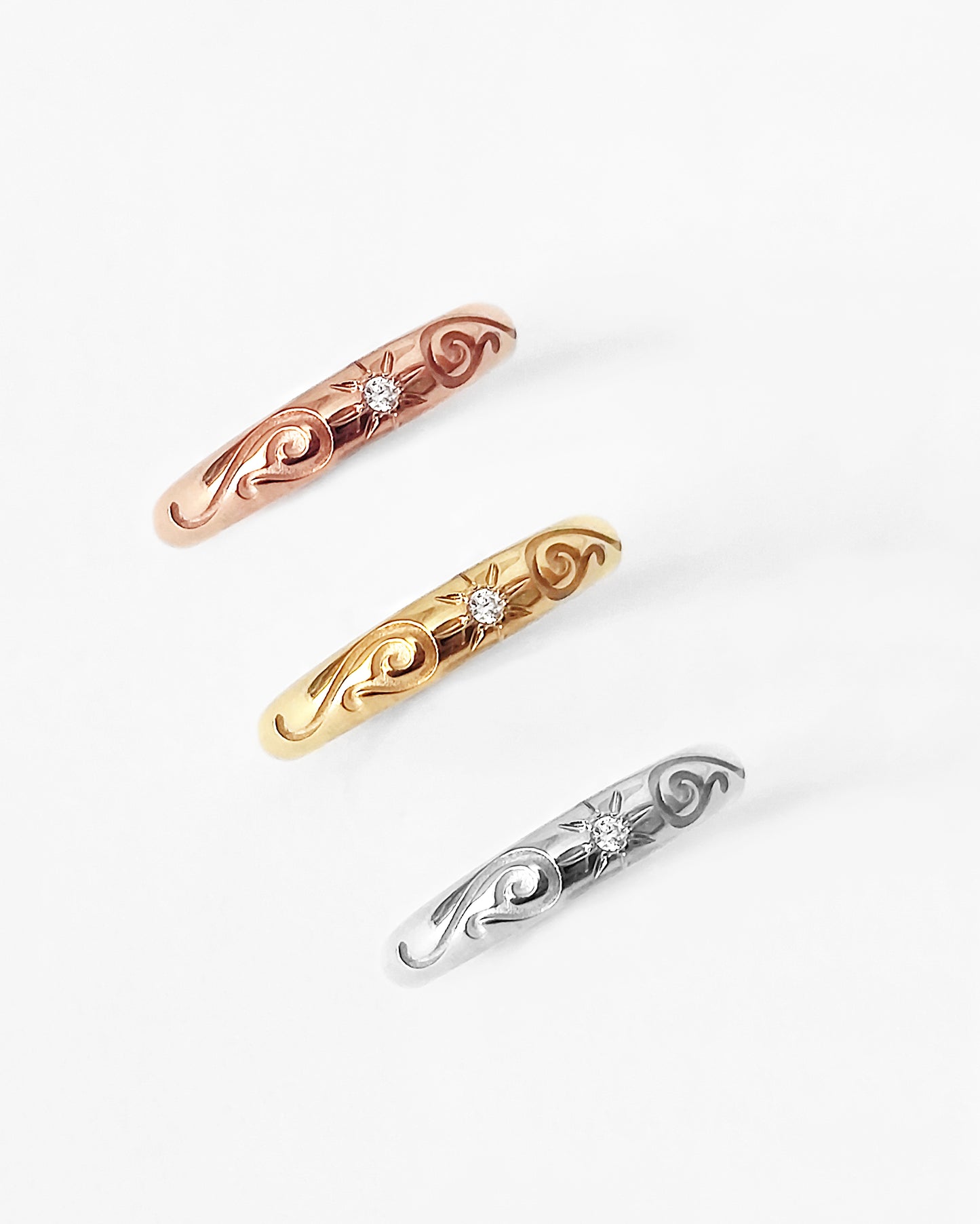 solid yellow rose and white gold dome band ring with floral designs and set with a white diamond with a star polaris setting