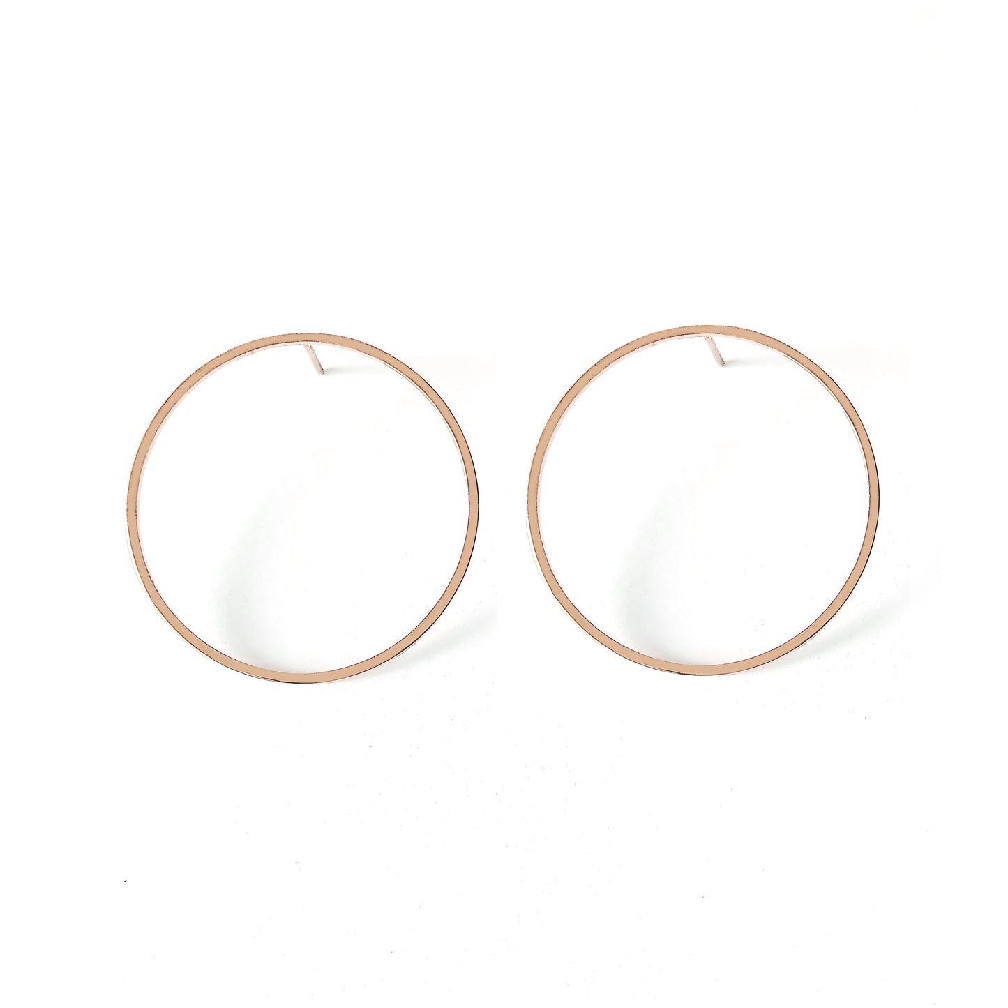 a pair of big open circle hoop stud earrings in solid rose gold