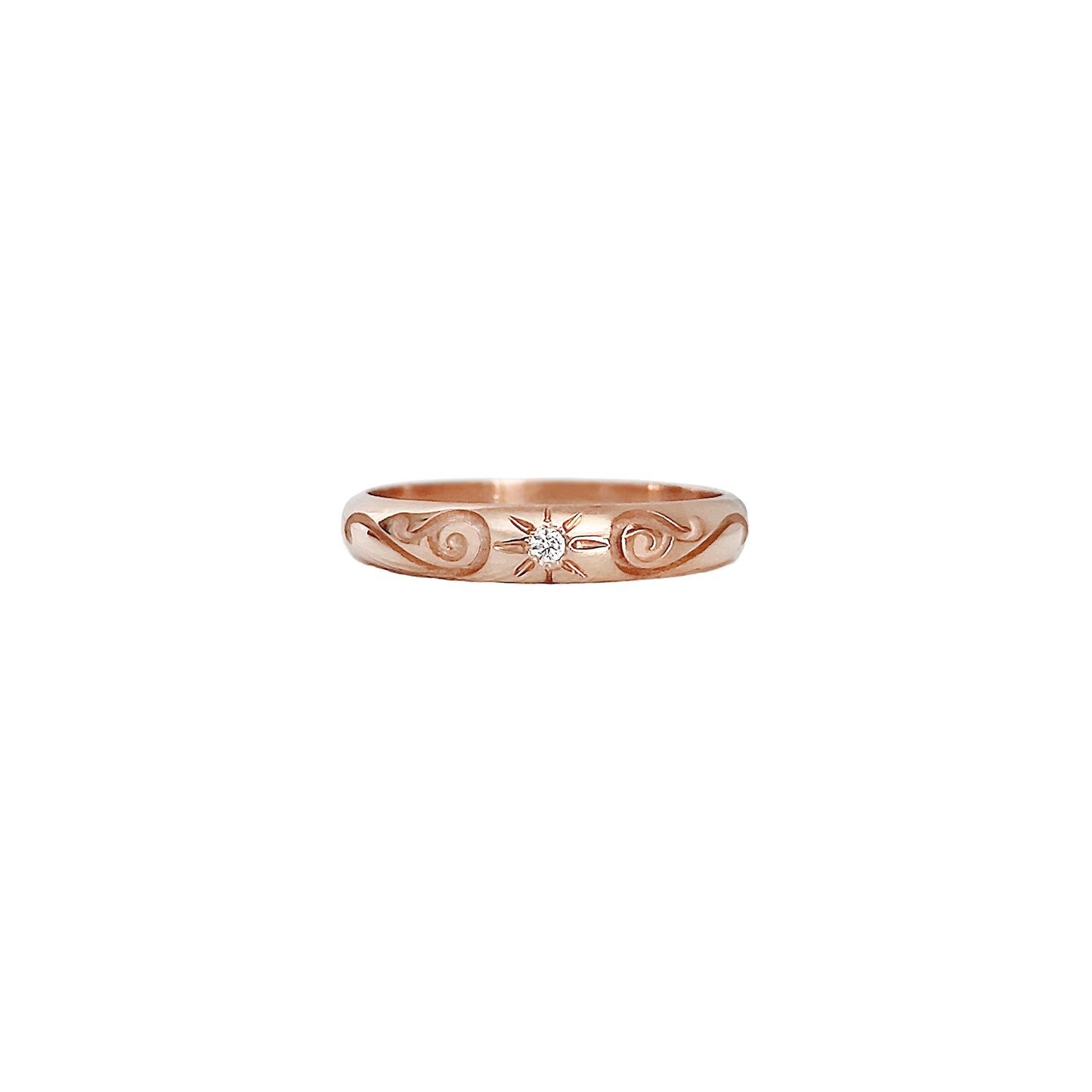 solid rose gold dome band ring with floral designs and set with a white diamond with a star polaris setting