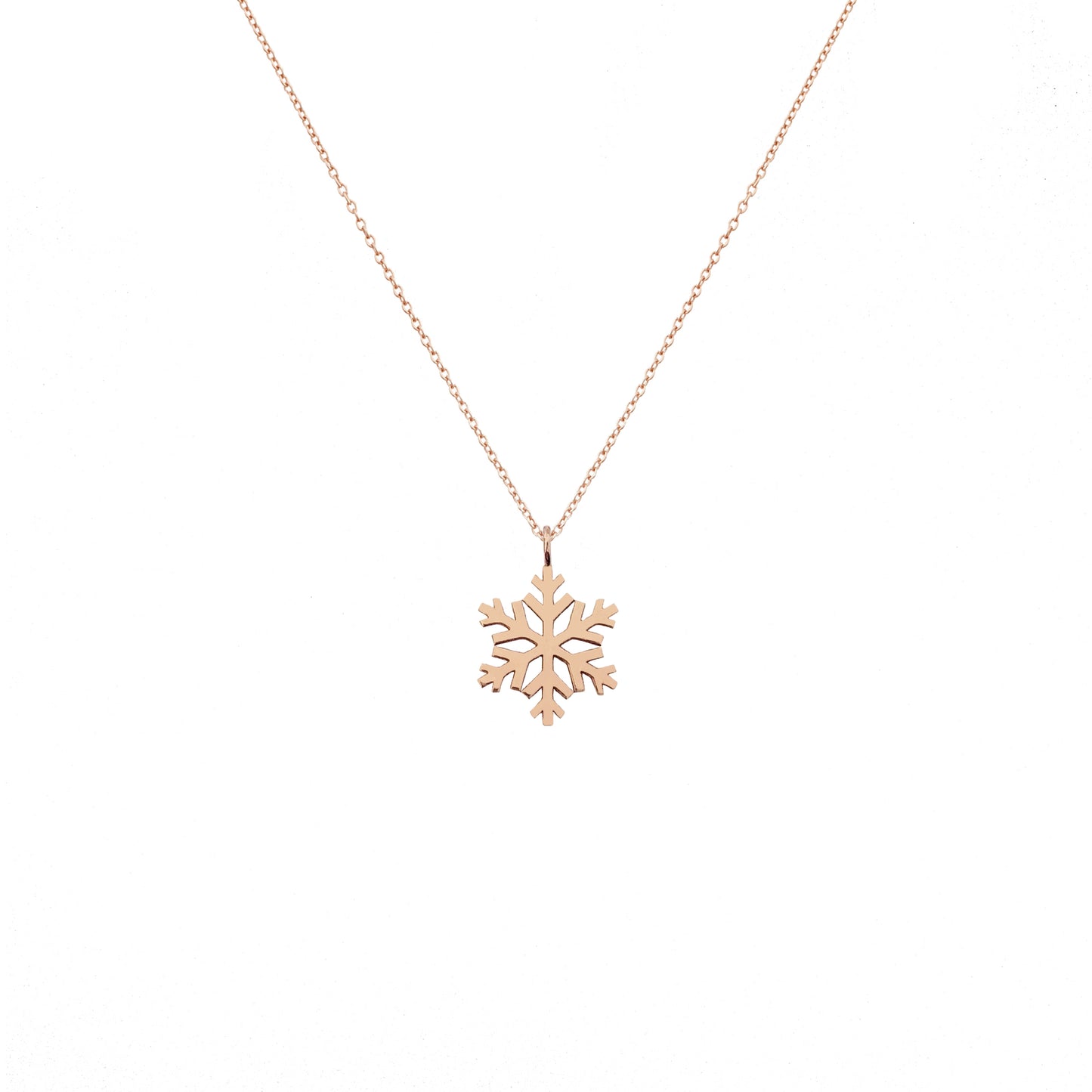 solid rose gold necklace with a small pendant in the shape of a snowflake