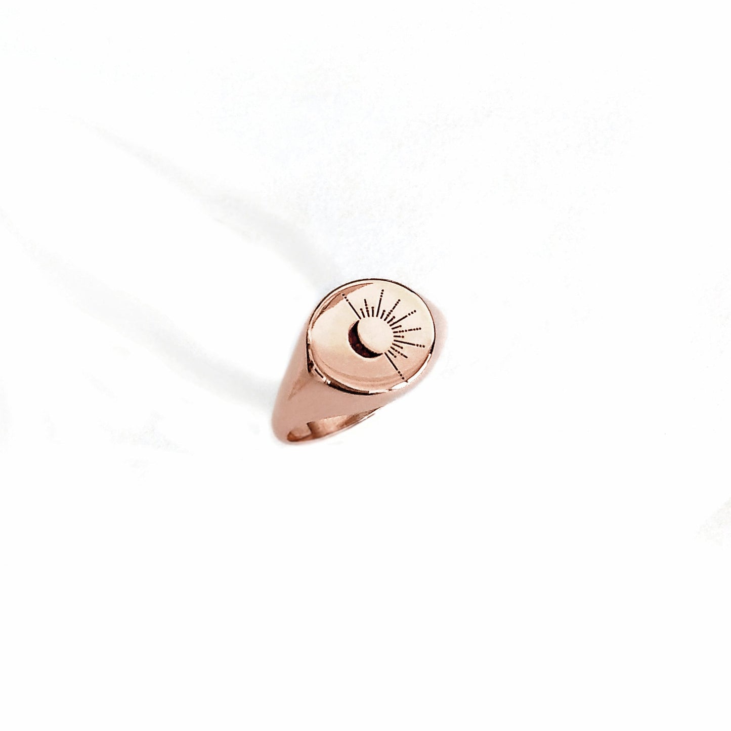 solid rose gold round signet ring engraved with the sun and moon