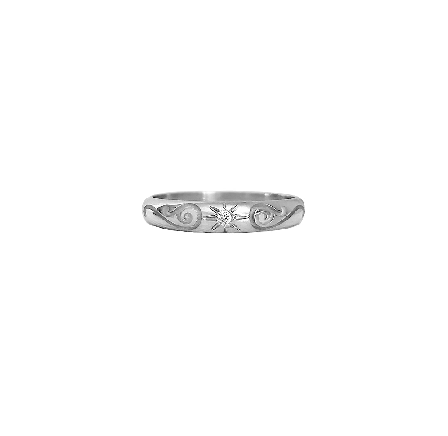 solid white gold dome band ring with floral designs and set with a white diamond with a star polaris setting