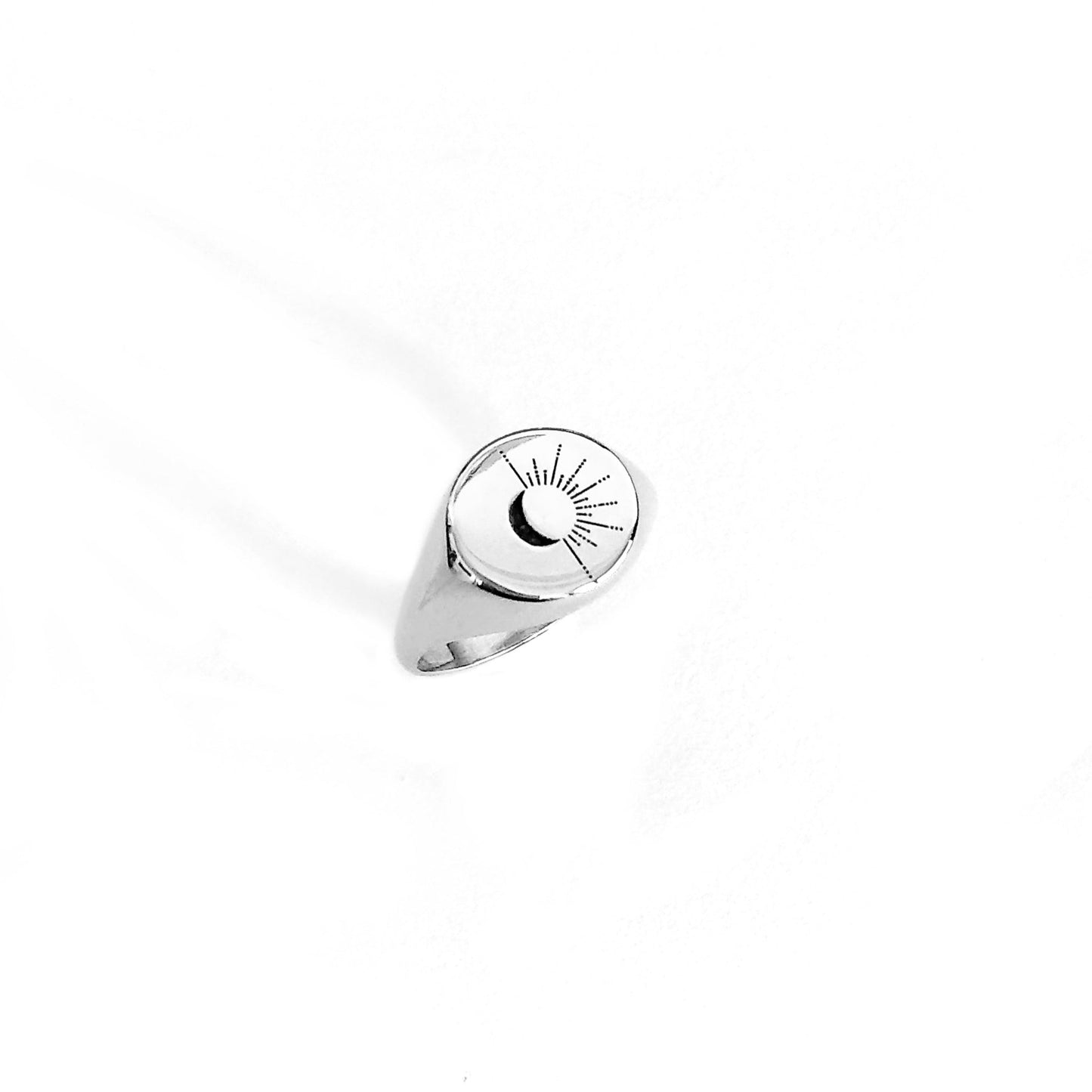 solid white gold round signet ring engraved with the sun and moon