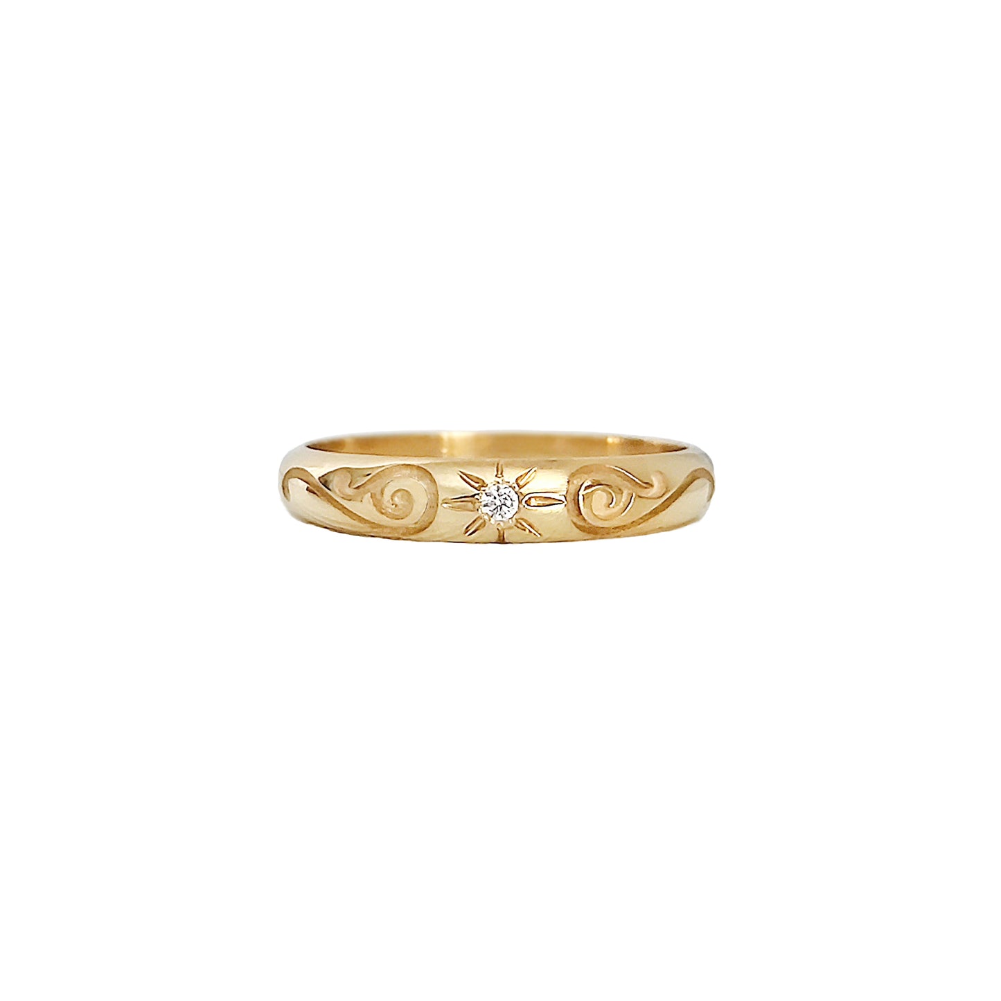 solid yellow gold dome band ring with floral designs and set with a white diamond with a star polaris setting