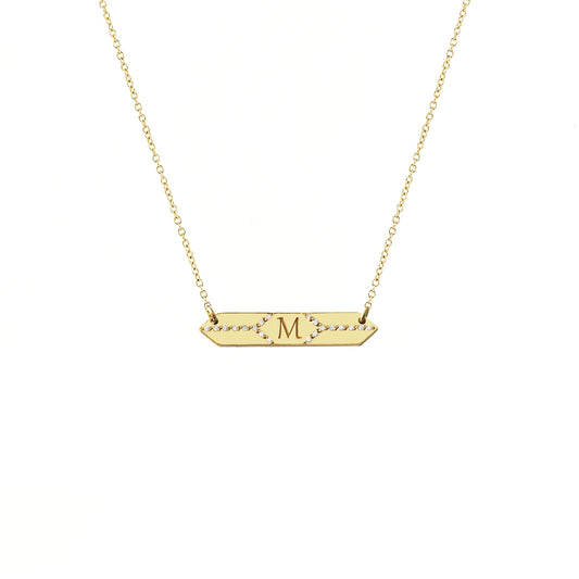 solid yellow gold hexagon bar necklace set with white diamonds and engraved with a custom initial/monogram in the center