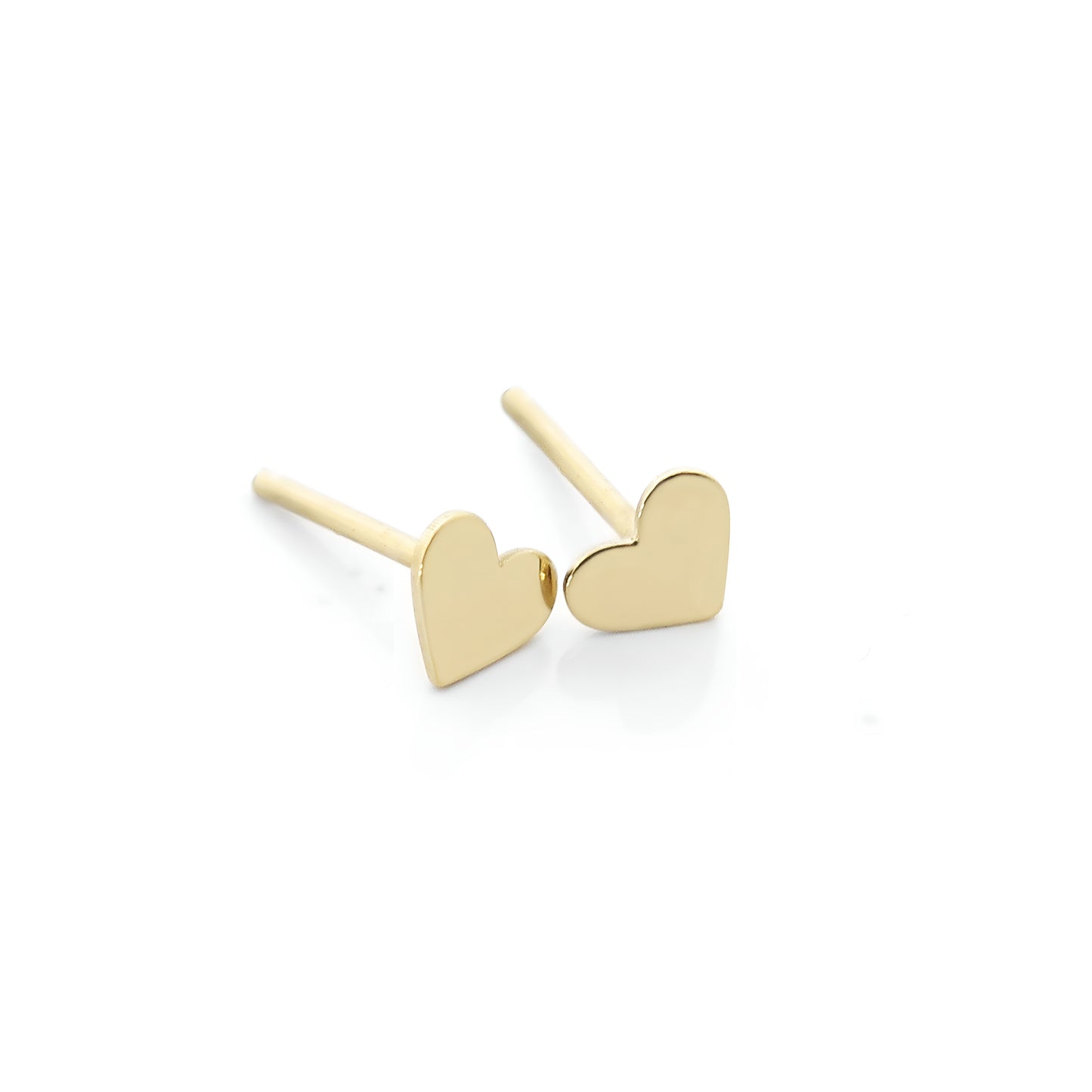a pair of solid yellow gold hear-shaped stud earrings