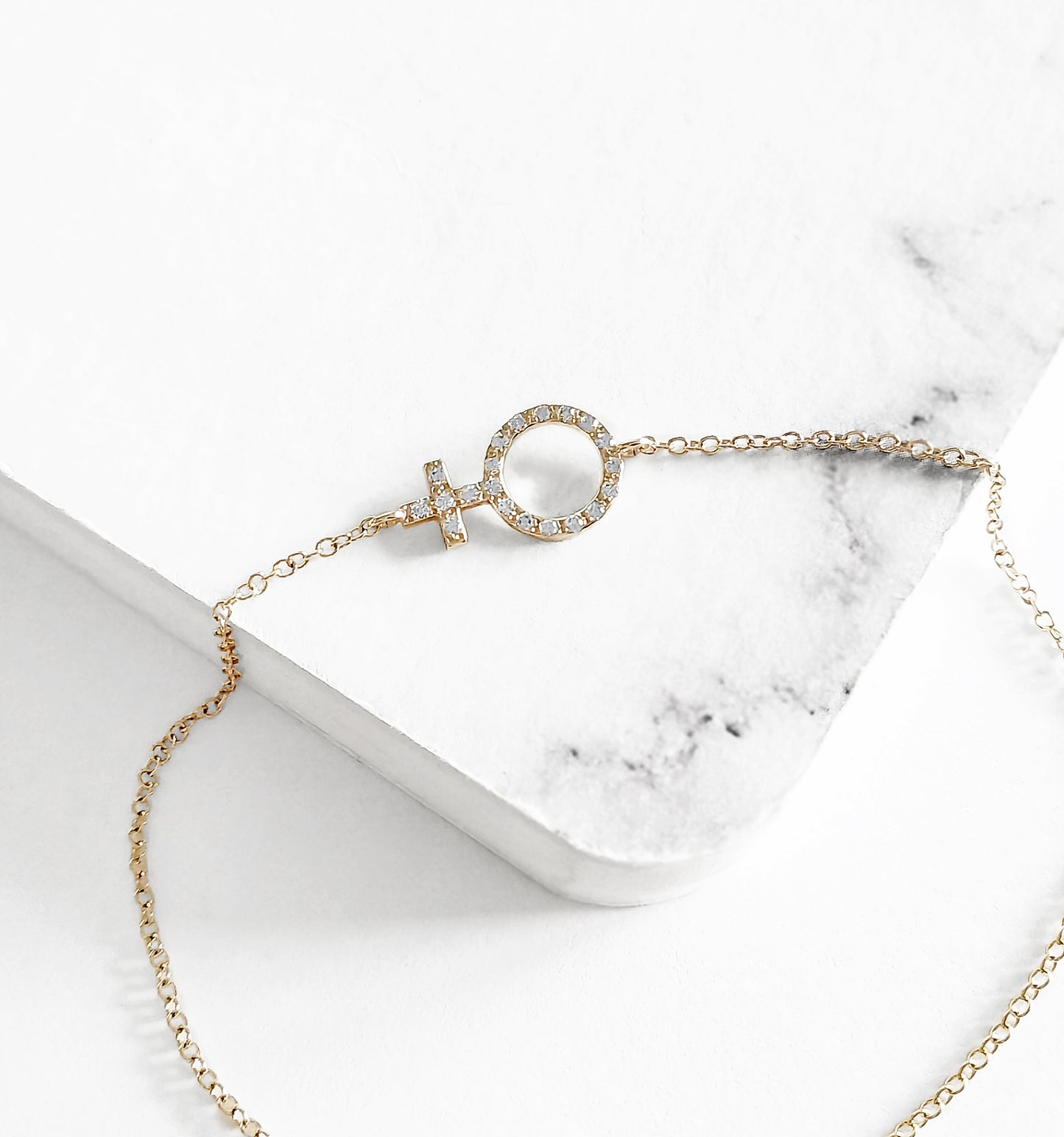 14K yellow gold bracelet with a venus female symbol charm set with tiny diamonds