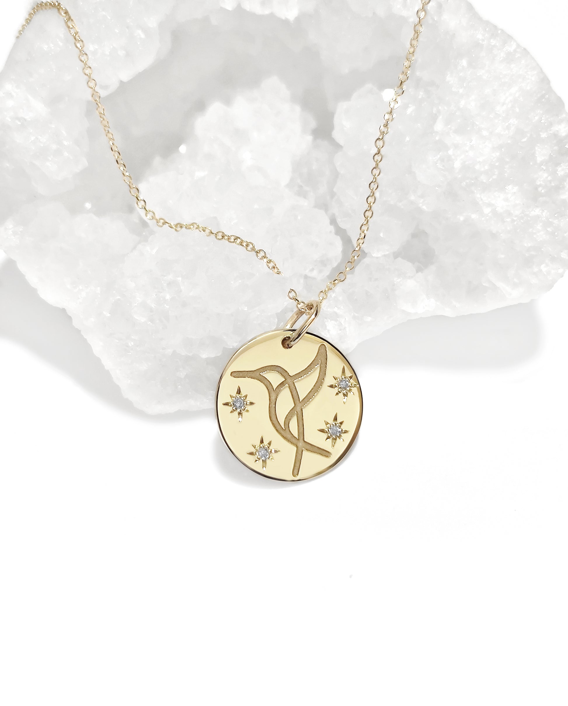 yellow gold necklace with 14mm disc pendant engraved with a hummingbird and set with four white diamonds with a star setting