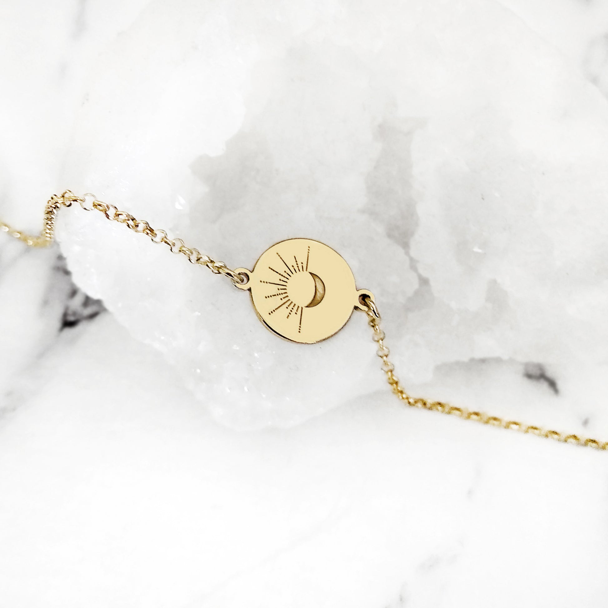 14K yellow gold disc charm bracelet engraved with a crescent moon and sun rays