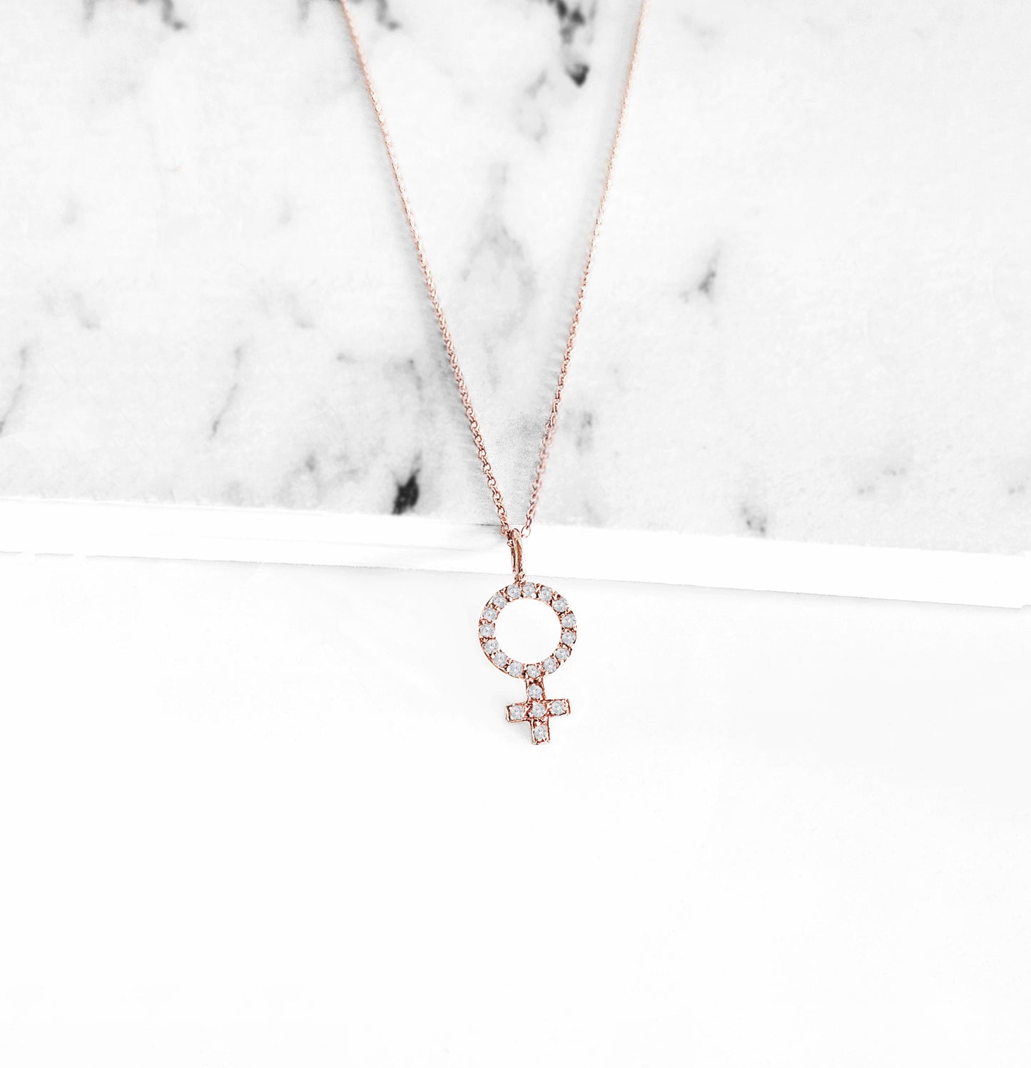 14K rose gold necklace with a female venus symbol charm set with white diamonds