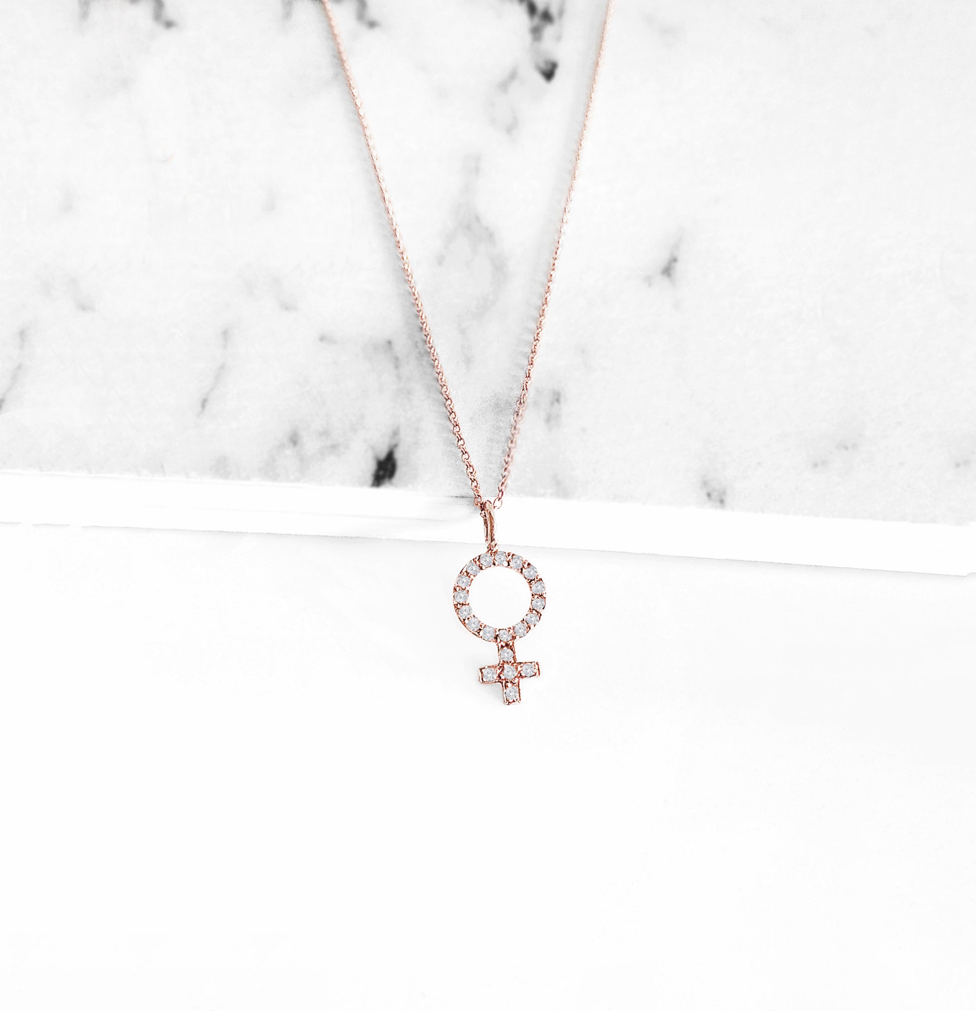14K rose gold necklace with a female venus symbol charm set with white diamonds
