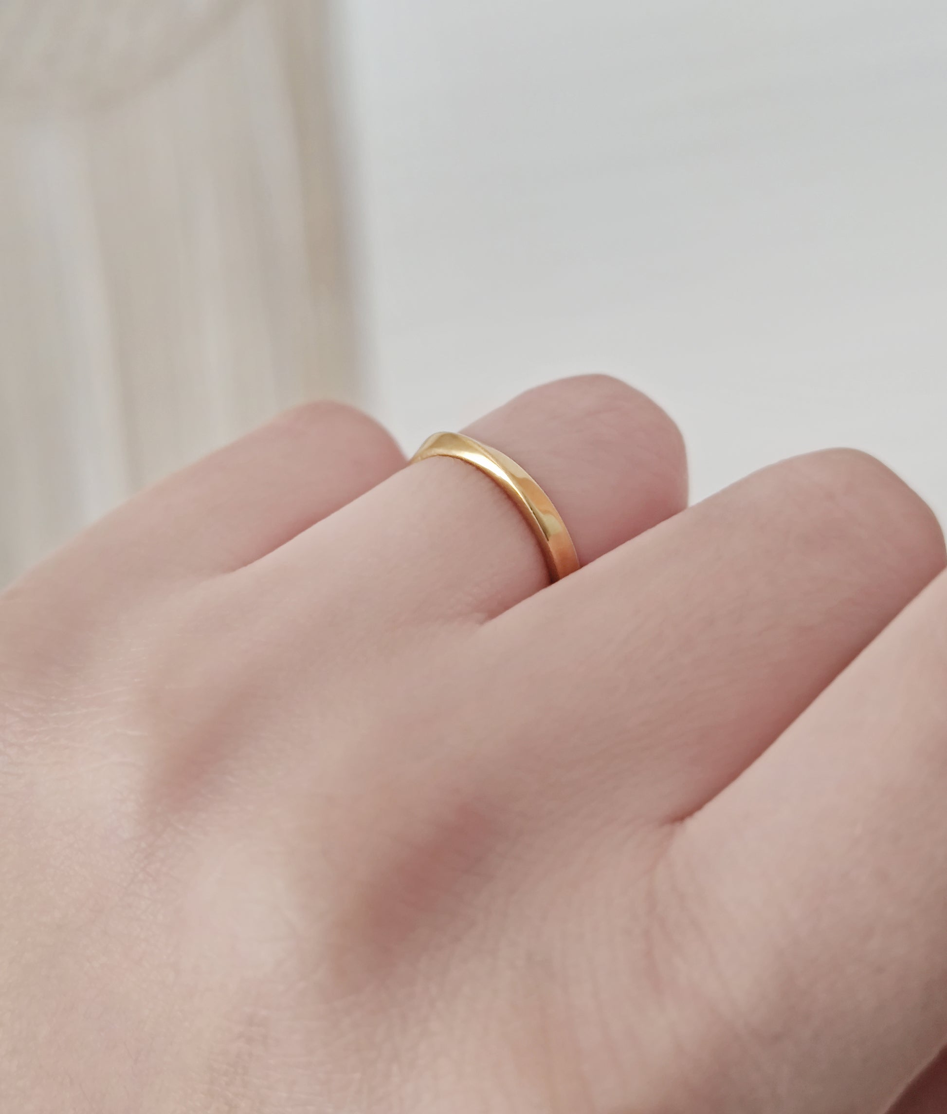 female wearing simple thin mobius wedding band