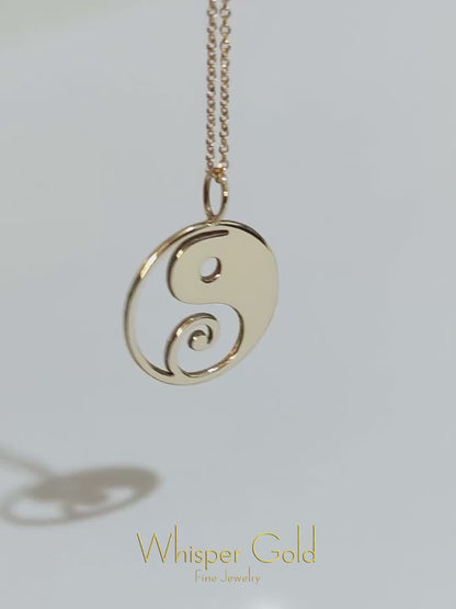 video of a solid yellow gold necklace with a 16mm yin yang pendant