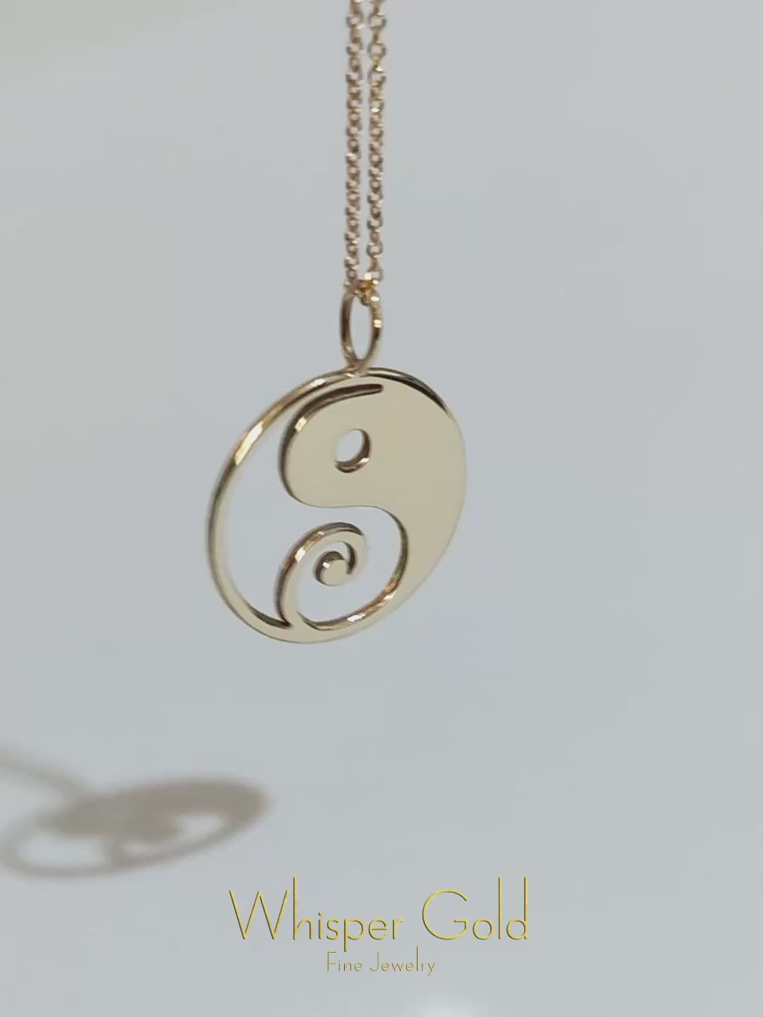 video of a solid yellow gold necklace with a 16mm yin yang pendant