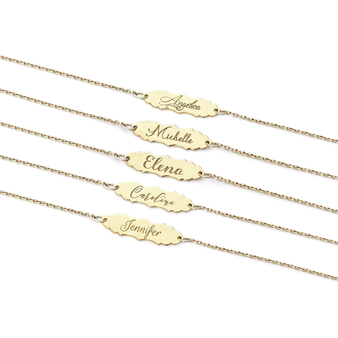 solid yellow gold bracelets with a vintage baroque inspired bar engraved with names in five different fonts