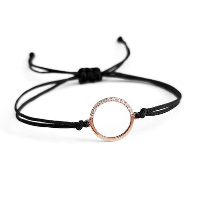 solid rose gold bracelet with an open circle charm set with 12 white diamonds 