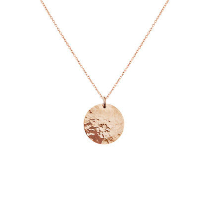 Solid rose gold necklace with a round hammered pendant on a white background