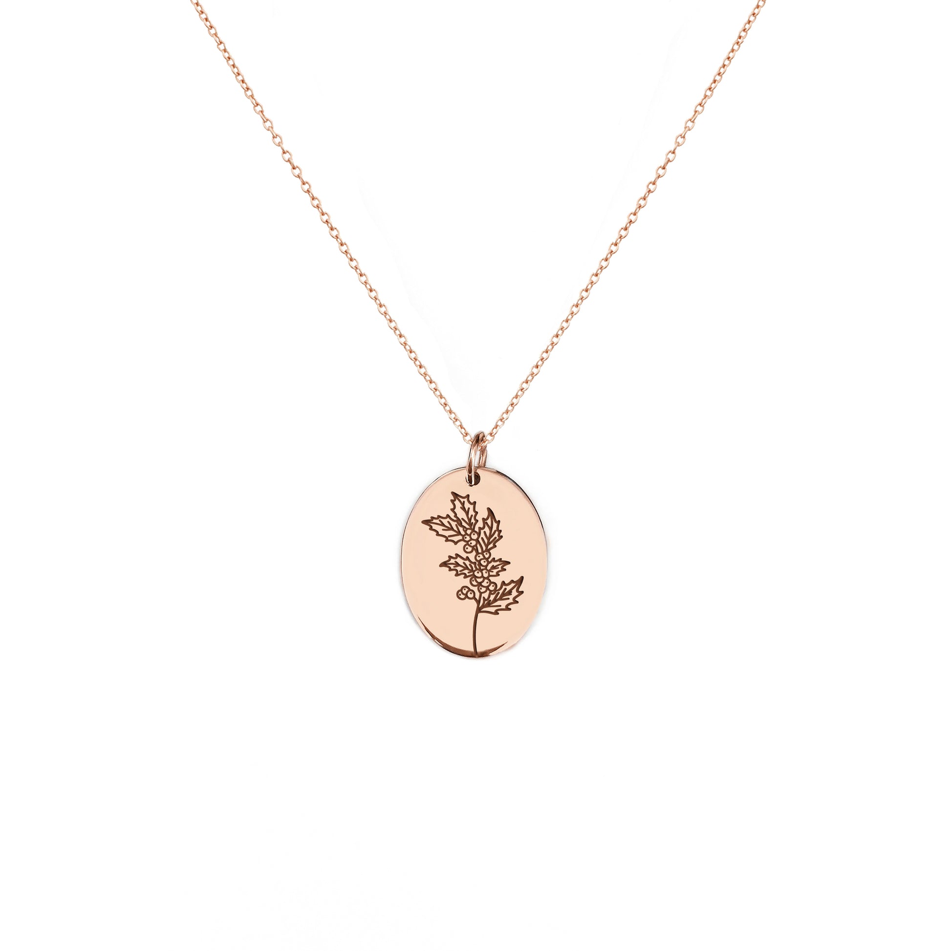 solid rose gold oval pendant necklace engraved with the birth flower of December Holly
