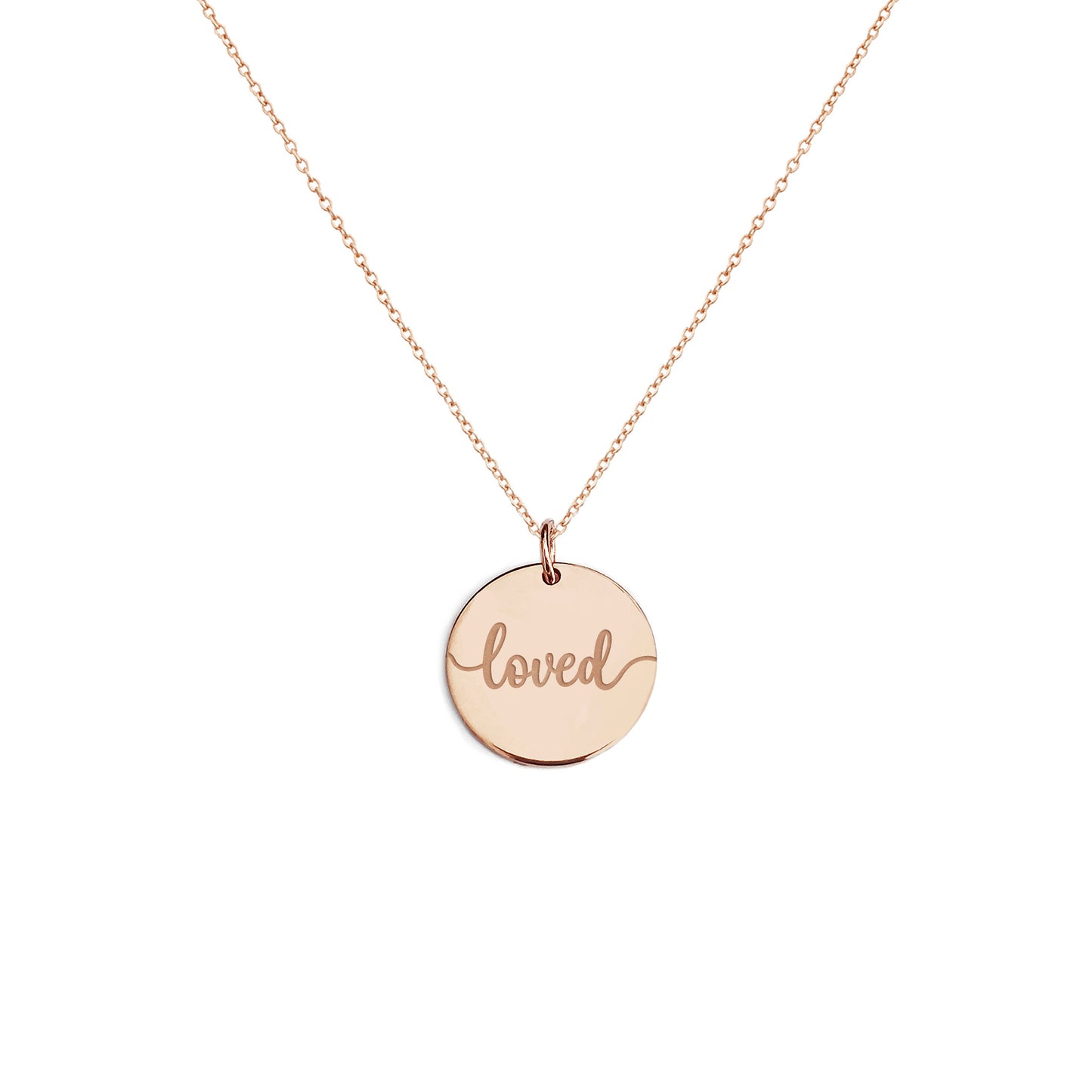 Solid rose gold necklace with a round pendant engraved with the word 'loved' on a white background
