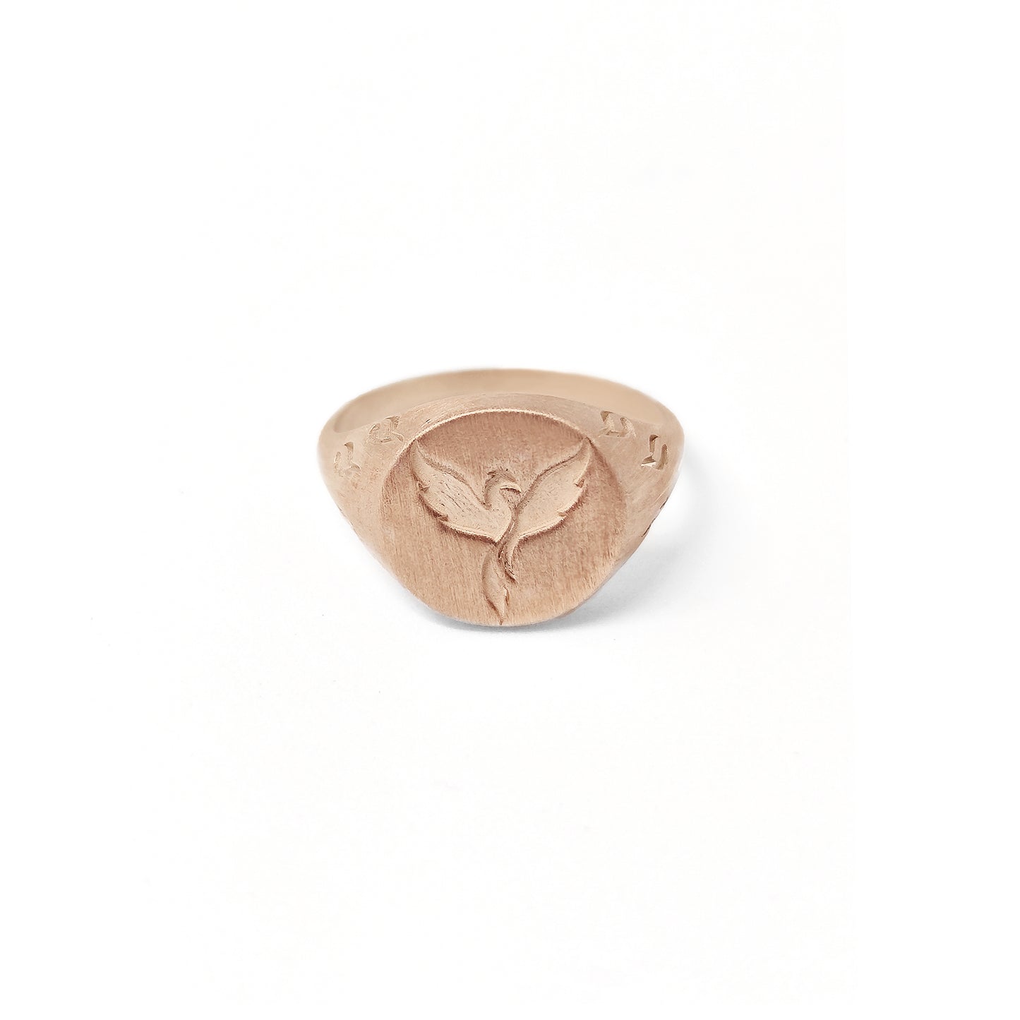 solid rose gold matte round signet ring engraved with a phoenix firebird rising with flame cutouts around the base of the ring's head