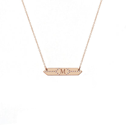 solid rose gold hexagon bar necklace set with white diamonds and engraved with a custom initial/monogram in the center