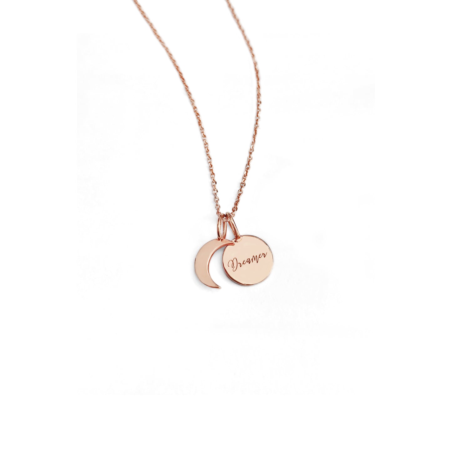 solid rose gold necklace with two small charms, a crescent moon and a personalized disc