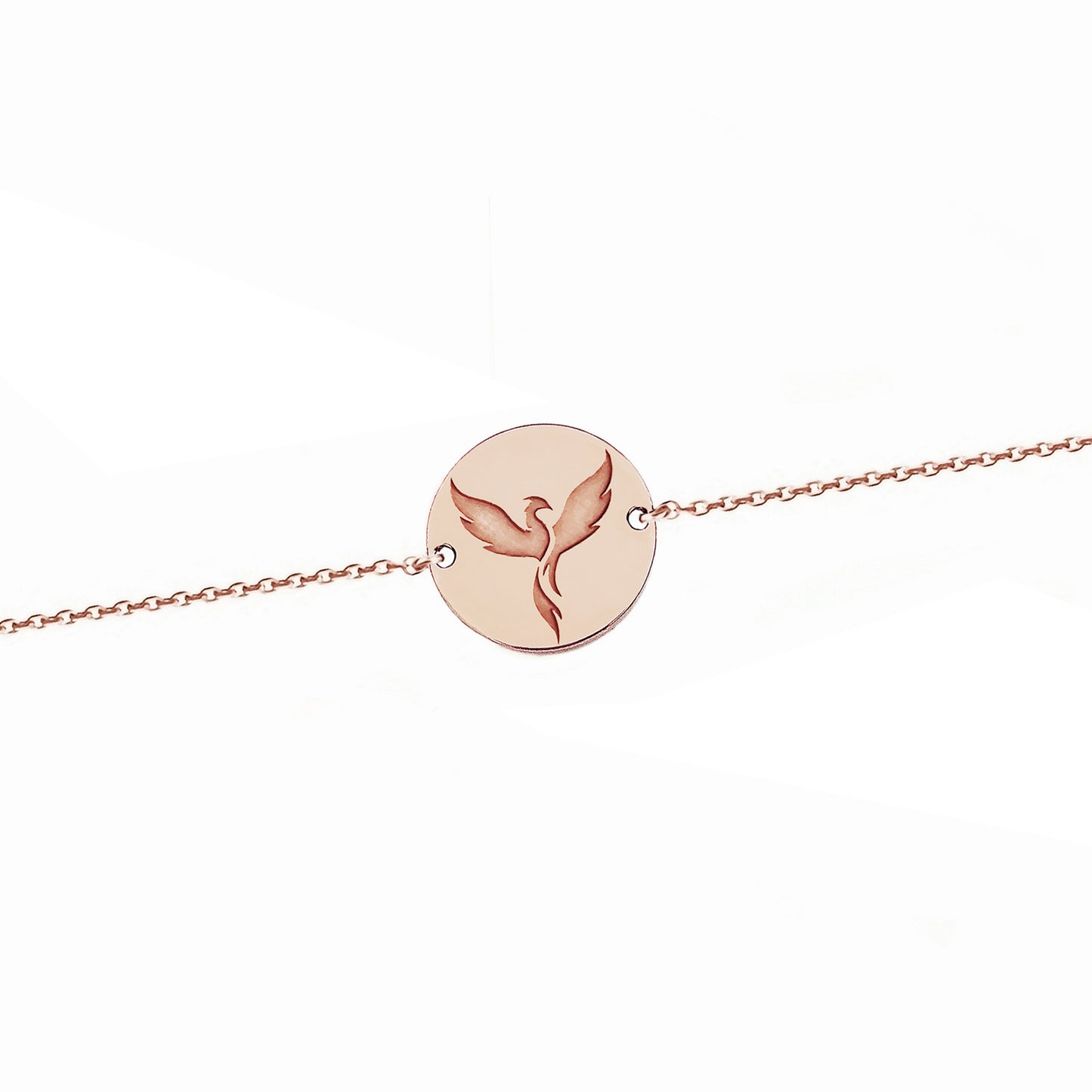 solid rose gold bracelet with a 14mm disc charm engraved with a phoenix firebird rising