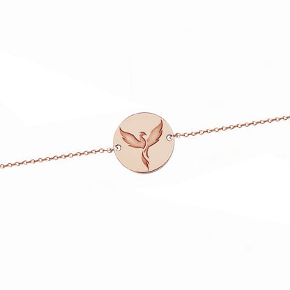 solid rose gold bracelet with a 14mm disc charm engraved with a phoenix firebird rising