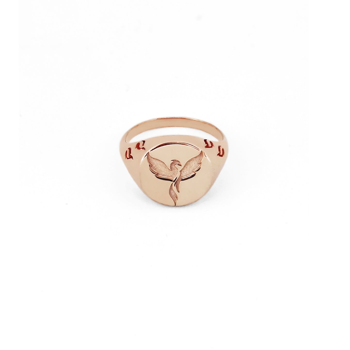 solid rose gold polished round signet ring engraved with a phoenix firebird rising with flame cutouts around the base of the ring's head