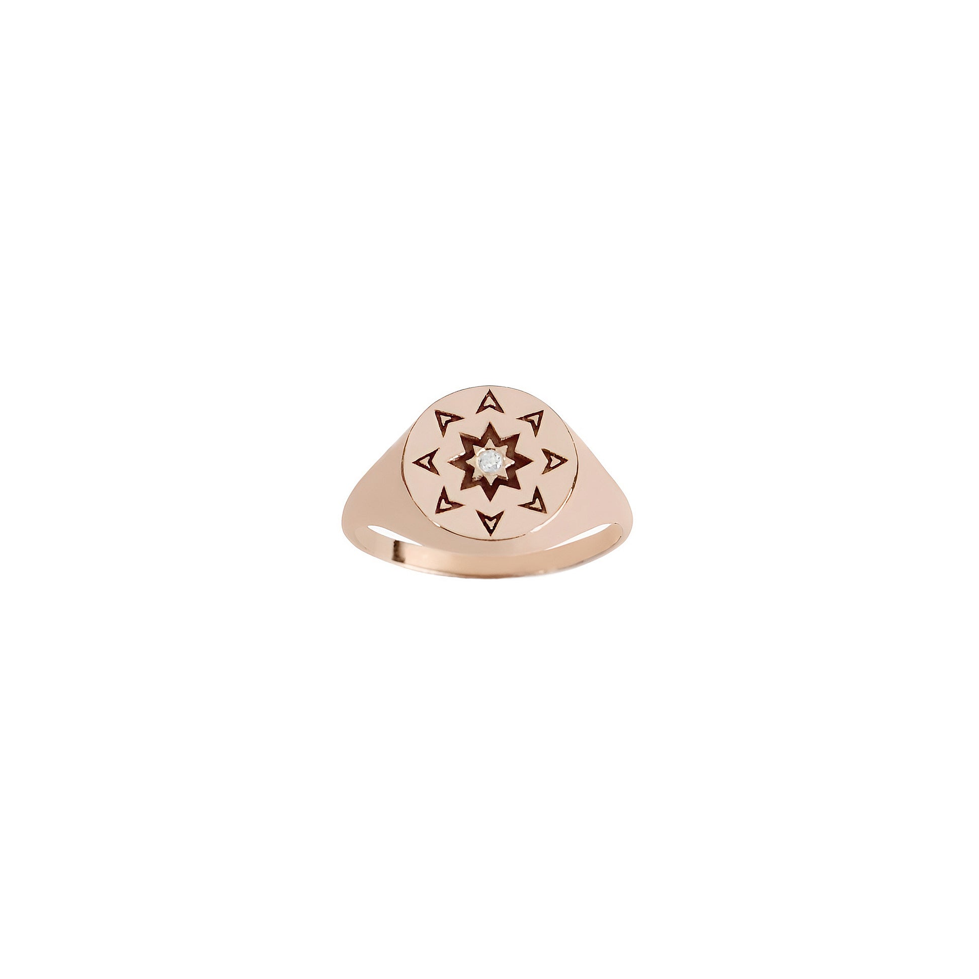 front view of a solid rose gold round signet ring with a north star starburst design and a diamond on the center