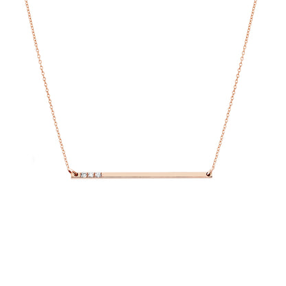solid rose gold thin bar necklace set with three tiny white diamonds