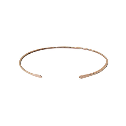 Rose gold open bangle with hammered finish on a white background