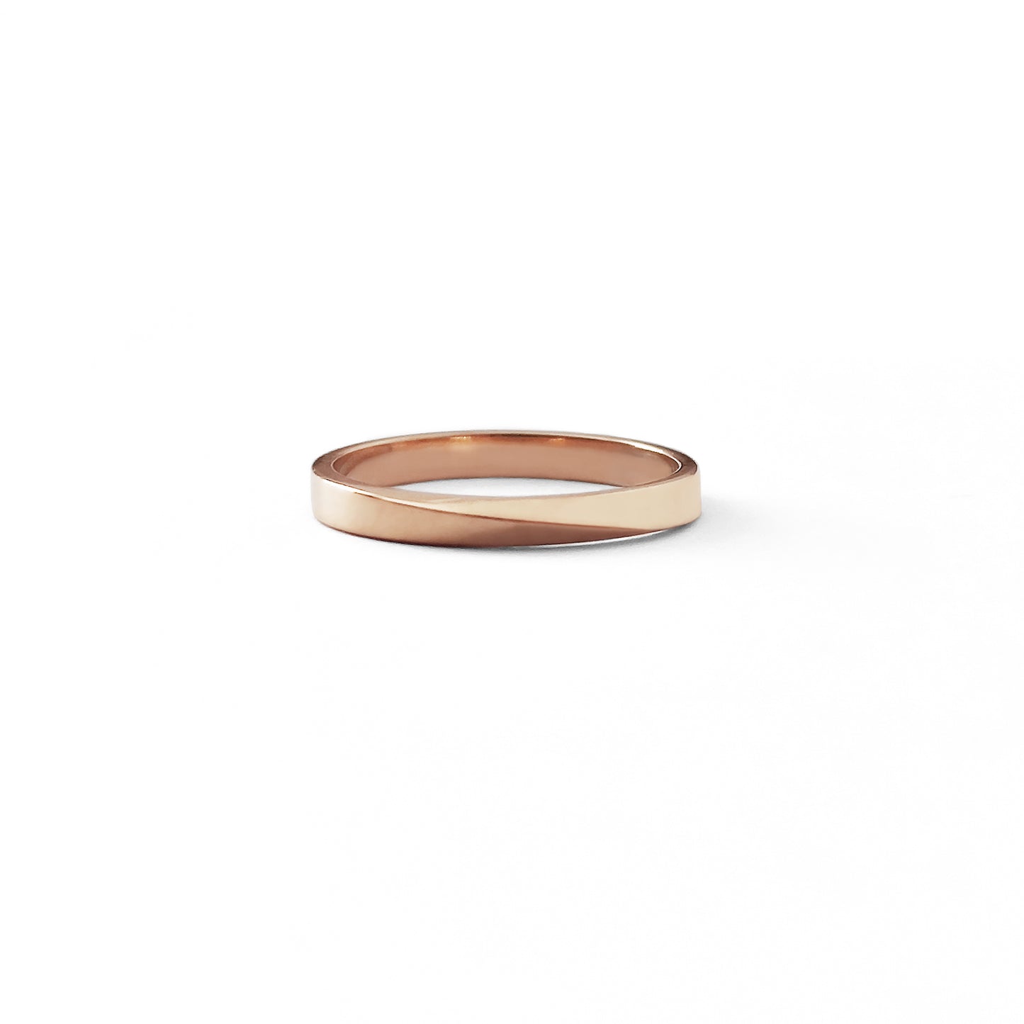 front view of a solid rose gold thin mobius wedding ring