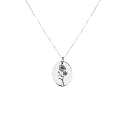 solid white gold oval pendant necklace engraved with the birth flower of April Daisy