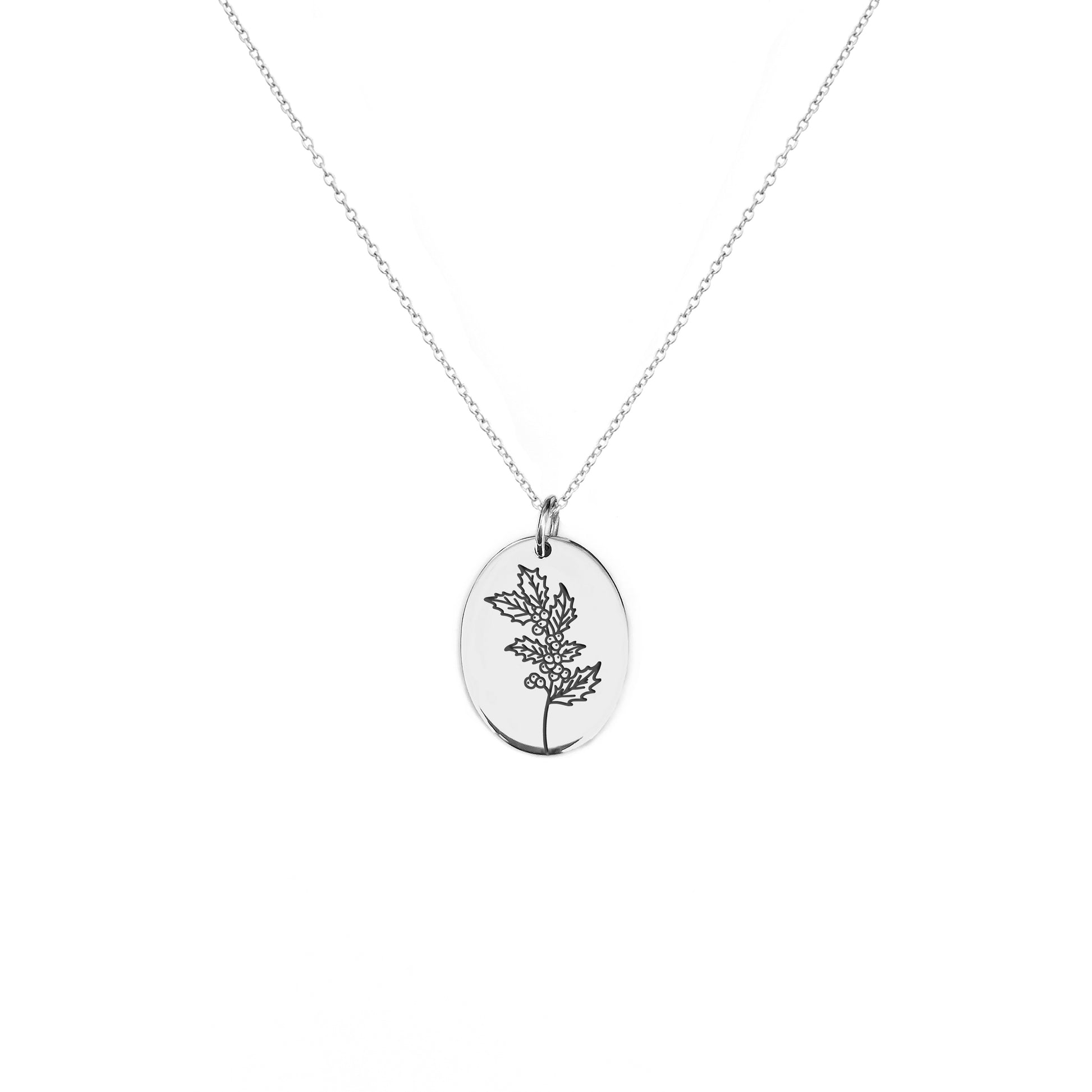 solid white gold oval pendant necklace engraved with the birth flower of December Holly