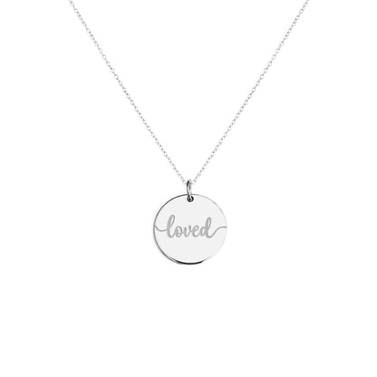 Solid white gold necklace with a round pendant engraved with the word 'loved' on a white background