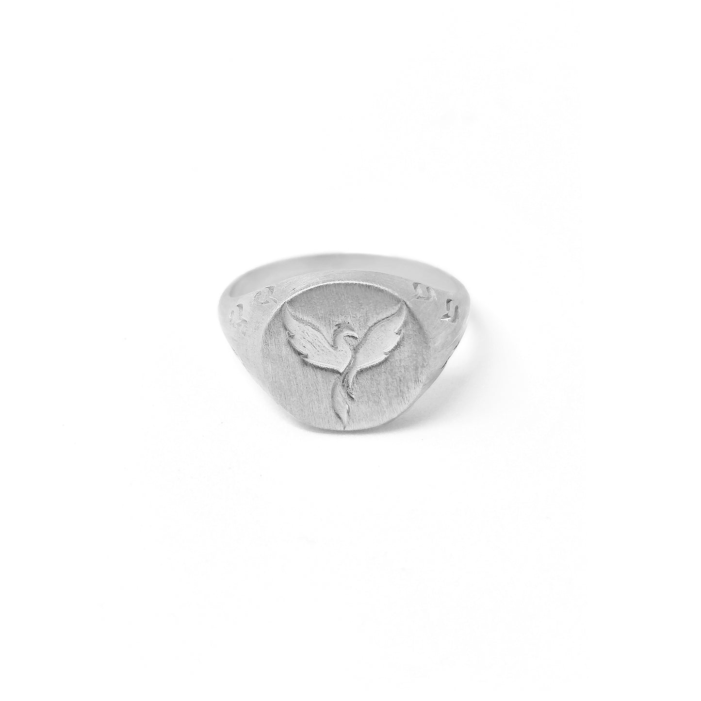 solid white gold matte round signet ring engraved with a phoenix firebird rising with flame cutouts around the base of the ring's head
