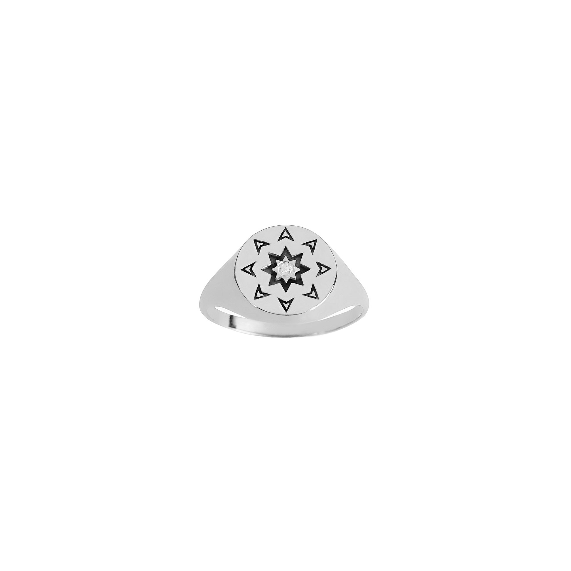 front view of a solid white gold round signet ring with a north star starburst design and a diamond on the center