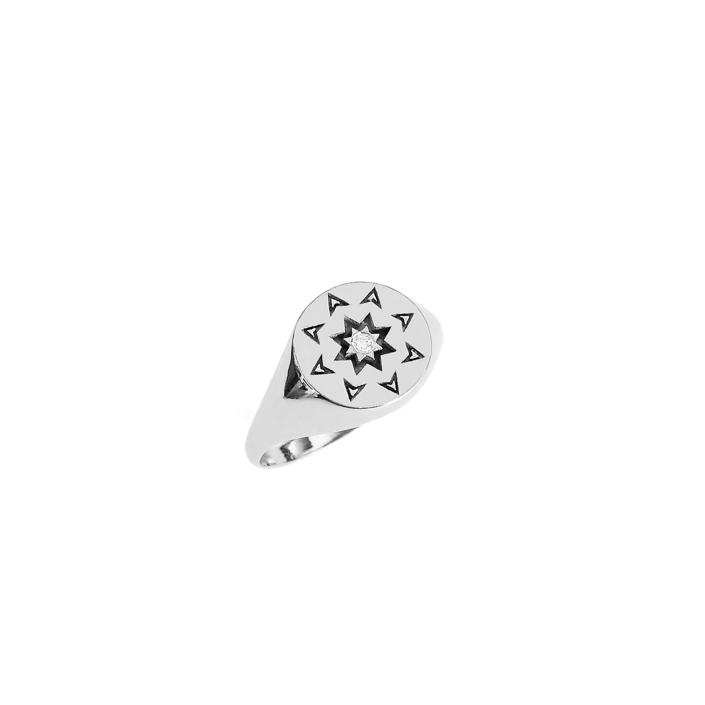 solid white gold round signet ring with a north star starburst design and a diamond on the center