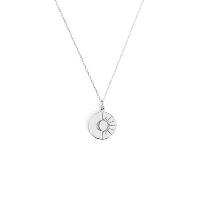 Solid white necklace with a circular pendant featuring a moon and sun design on a white background