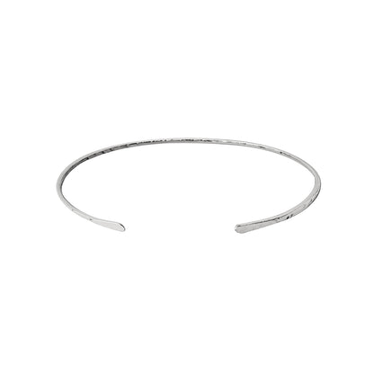 White gold open bangle with hammered finish on a white background