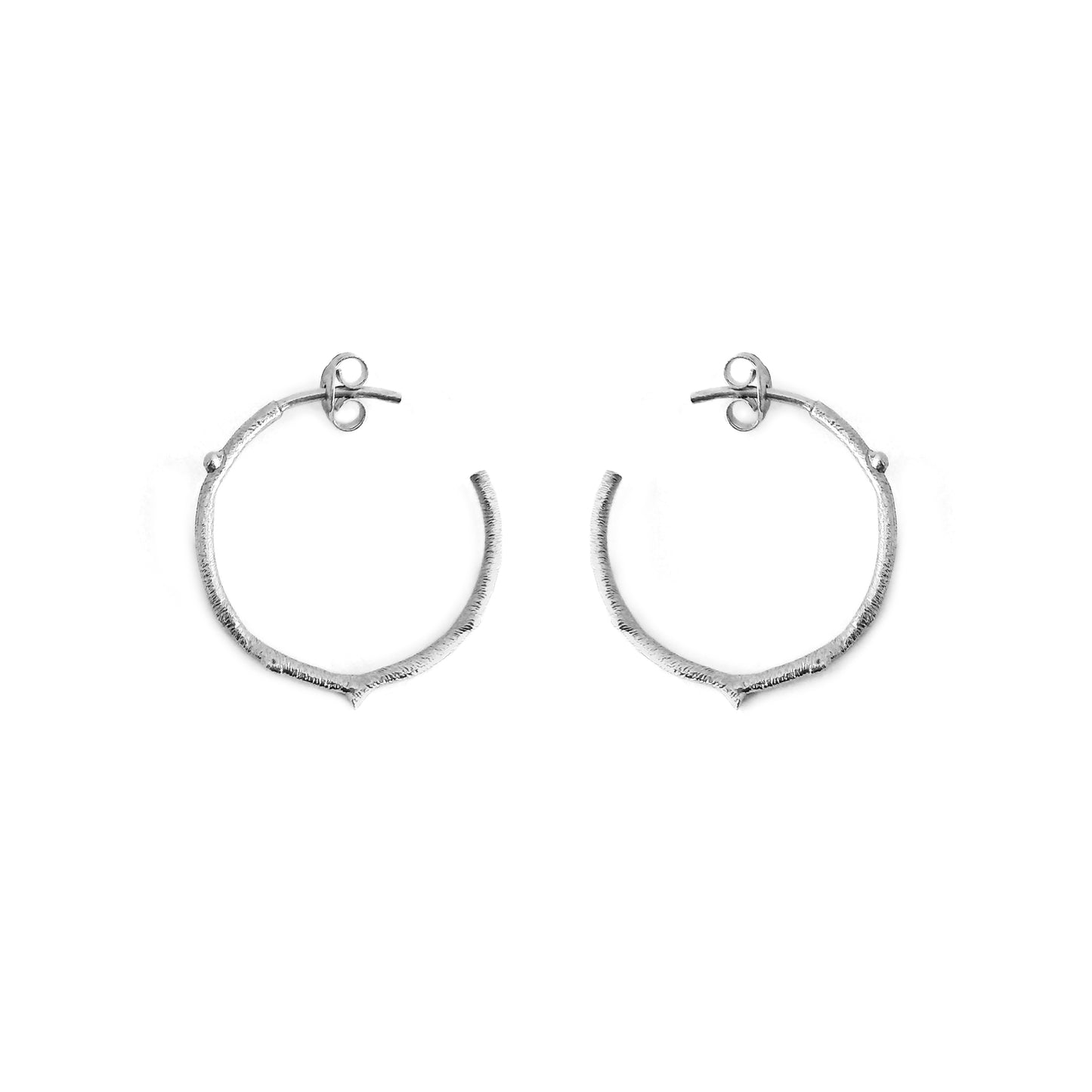 pair of solid white gold hoop earrings with a twig branch like design