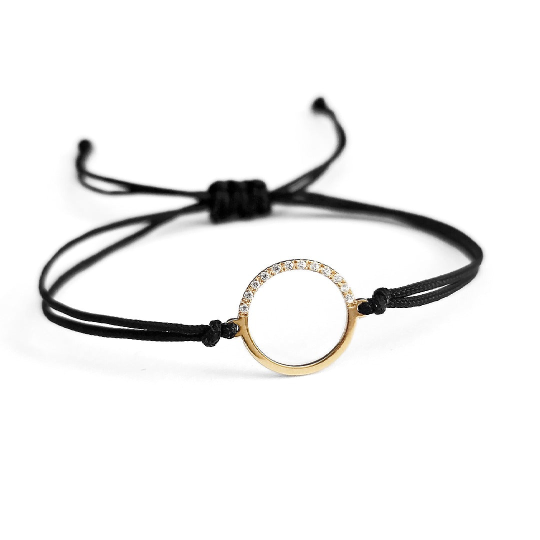 solid yellow gold bracelet with an open circle charm set with 12 white diamonds 