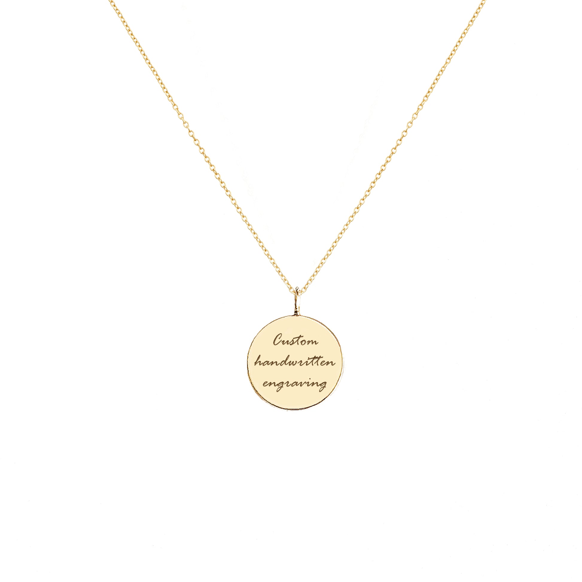 Gold necklace with a round pendant with handwritten engraving on a white background