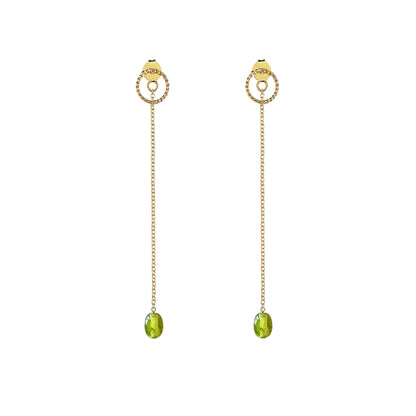 pair of solid yellow gold jacket earrings with a small twisted circle stud on the front and a long chain with a peridot bead at the end dangling on the back