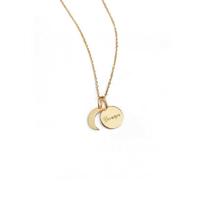 solid yellow gold necklace with two small charms, a crescent moon and a personalized disc