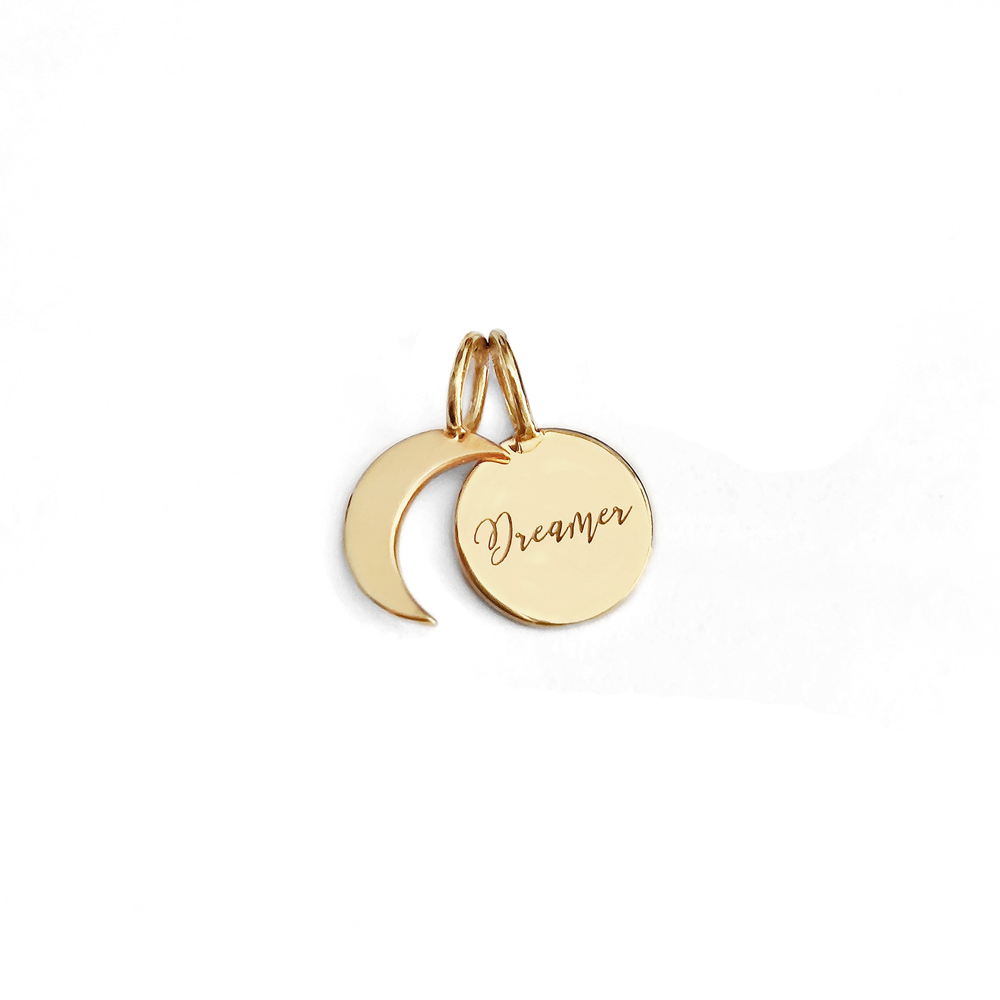 two small solid yellow gold charms, a crescent moon and a personalized disc